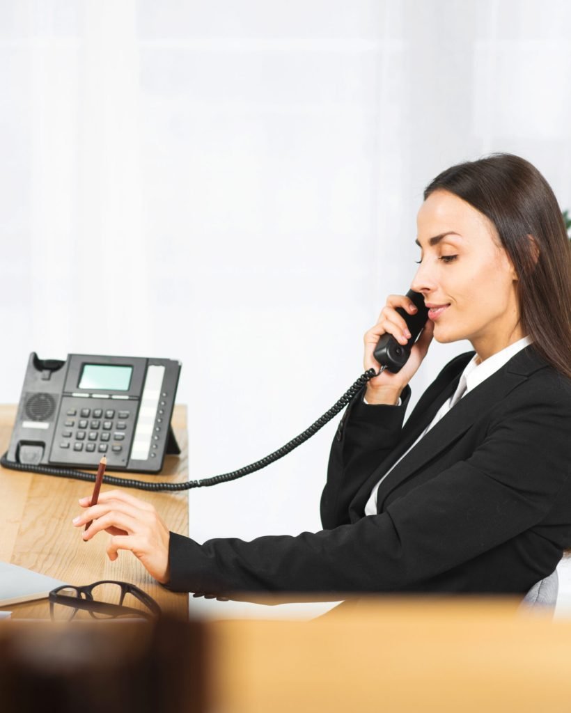 side-view-young-woman-holding-pencil-hand-talking-telephone